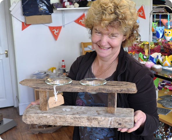 Sam at Crafty corner holding driftwood tealight holder